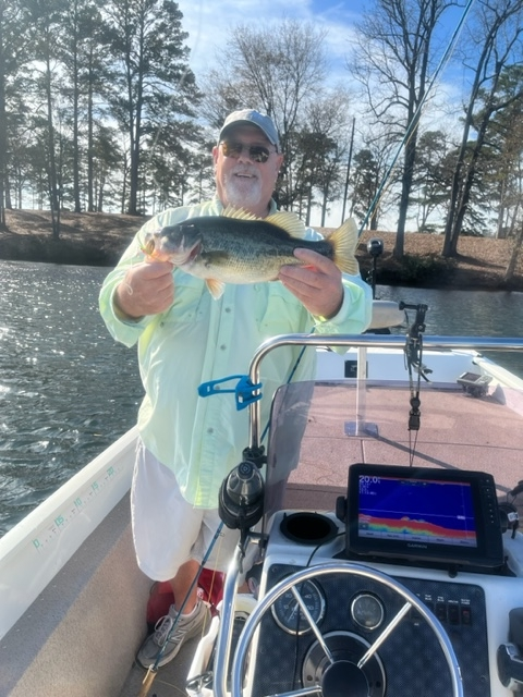 Angler in Lake Fork with Bass